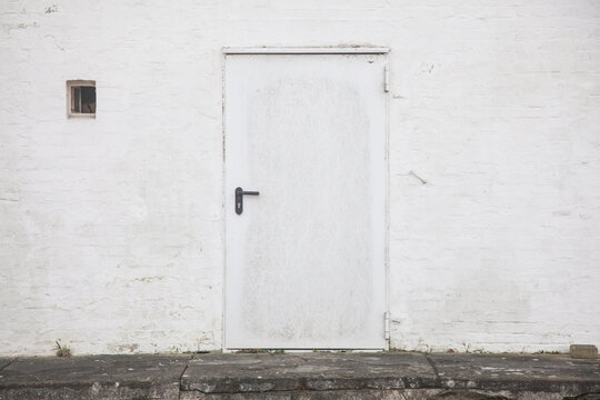 Painted white door and brick wall
