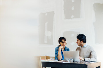 Smart colleagues analyzing data on laptop