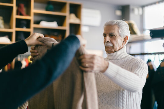 Elderly client choosing clothes in store
