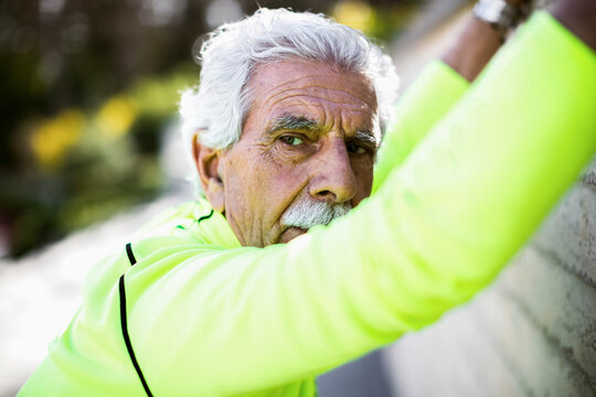 Aged athlete exercising near wall