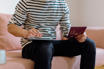 Crop man entering passport credentials on smartphone