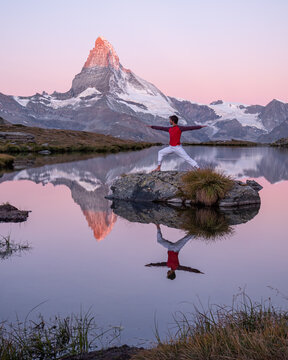 Warrior pose in nature on a lake near the Matterhorn