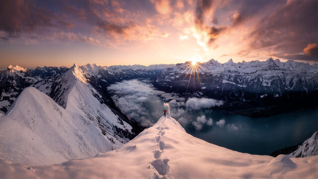 Man standing on mountain top at sunrise