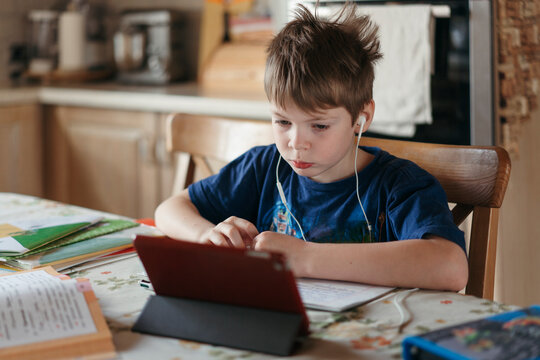 Quarantined Young Schoolboy Studies From Home.