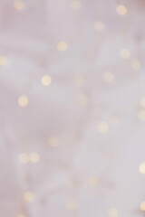 Gently pink background with small festive bokeh. Can be used as hygge background for xmas, wedding invitations or card. Cozy home backdrop.