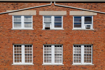 Fototapeta na wymiar Exterior Wall of an Old Brick Building with Windows