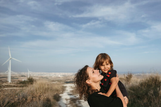 A young mother with a little daughter on a walk.