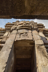 Fototapeta premium Huge carved stone face, in one of the shrines of the Prambanan ancient Hindu temple complex, Rara Jonggrang, in the Special, Yogyakarta region, Indonesia.