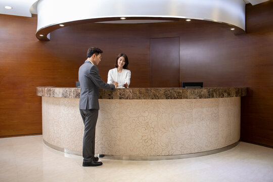 Businessman checking in at front desk