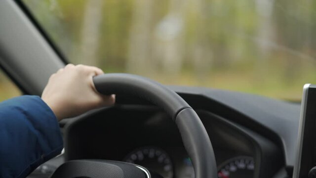 Female driver hands on steering wheel woman driving car closeup. High quality 4k footage