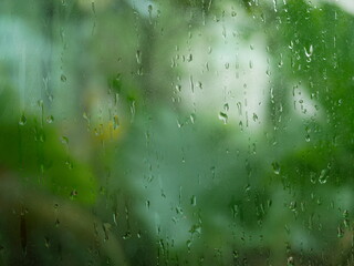 rain water drops on the window glass in rainy day.