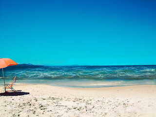 Beach landscape, sea sand and umbrella.