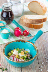 pan with salad ingredients on wooden background, close view 