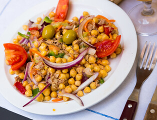 Empedrado garbanzos, traditional spanish salad with chickpeas, crumbled cod, olives, tomato, onion and bell pepper