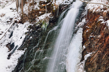 Natural water cascade in winter . Frost waterfall scenery 