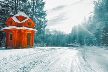 Wooden hut in the winter forest . Coniferous Woodland lake in Fairytale 