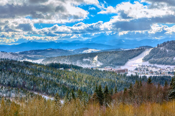 Fototapeta na wymiar Ski resort in the mountains . Winter landscape with forest and mountains