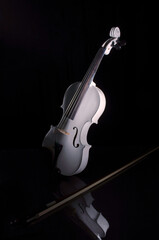 Still life photography of a violin and bow.