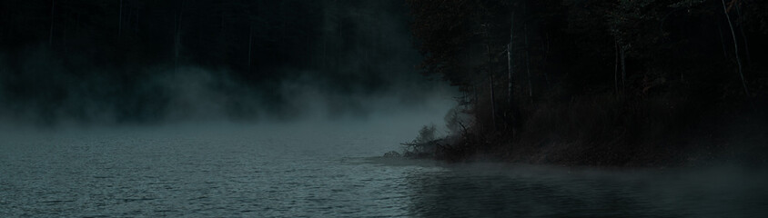 Mysterious foggy scene on the lake. Bozcaarmut lake in Bilecik Turkey in the autumn early morning. Panoramic view.
