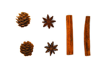 Christmas seasoning star anise, decor cones and cinnamon sticks isolated on a white background