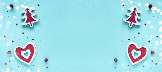 Christmas composition with red and white decorations with bokeh and snow on pastel blue surface, top view, copy space. Merry Christmas and Happy Holidays greeting card, frame, banner, flat lay