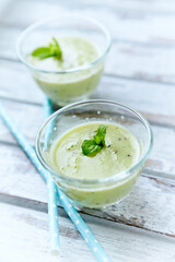 Green smoothie topped with chia seeds on bright wooden background. Close up.	
