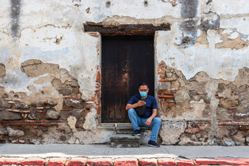 person in front of an old wall in antigua guatemala