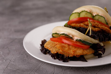 Steamed wheat bun dressed with designer sauce. Vietnamese cuisine concept. Still life. Close-up.