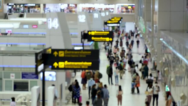 High view shot of Passengers walking in the airport. air travel opening after coronavirus epidemic. everyone wear disposal mask. blur focus