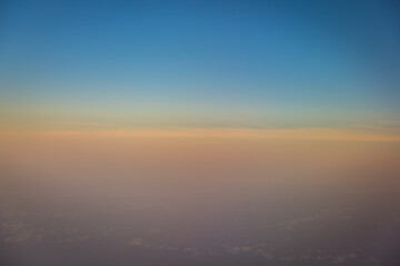 Fototapeta na wymiar Beautiful blue sky before sunset with clouds shoot on airplane