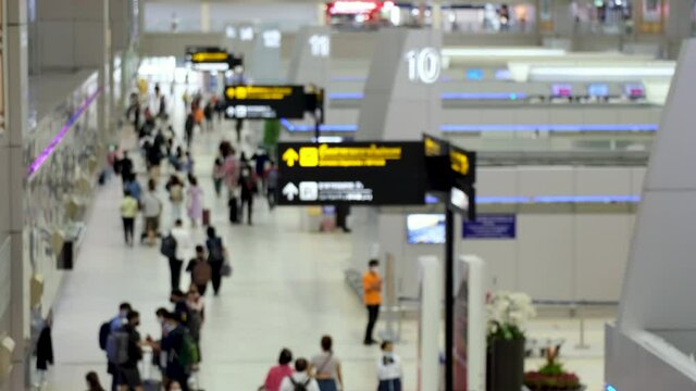 High view shot of Passengers walking in the airport. air travel opening after coronavirus epidemic. everyone wear disposal mask. blur focus
