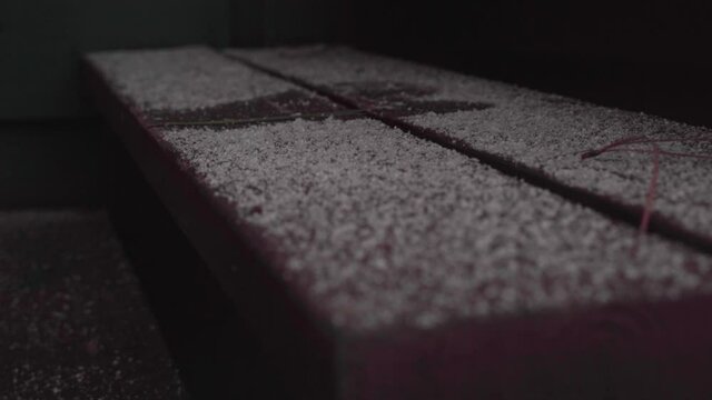 Footprint in Lightly Snow Covered Wooden Stair Step
