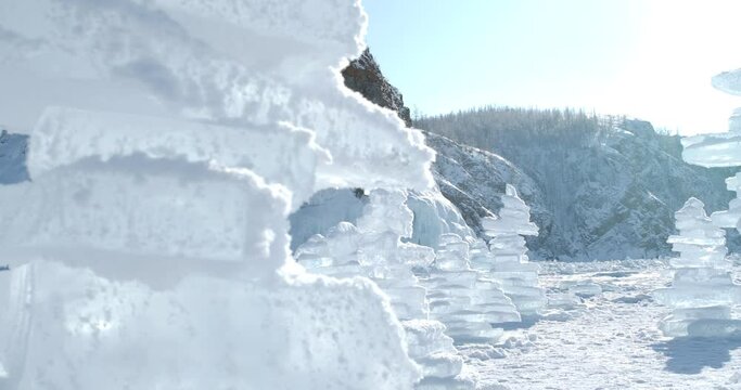A stack of transparent ice floe crystals on the surface of a frozen Lake Baikal in winter. Siberia, Russia. Winter tourism concept. Gimbal dolly shot.