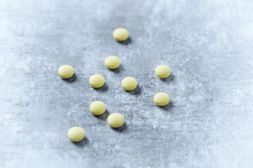 Vitamin C tablets on wooden background. Close up. Copy space.	