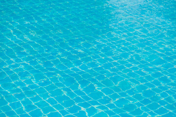 Reflections from the water in the blue swimming pool