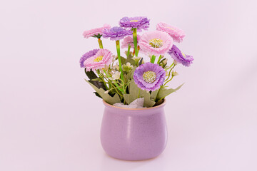 Naklejka premium Flowers made of colorful paper in a purple vase