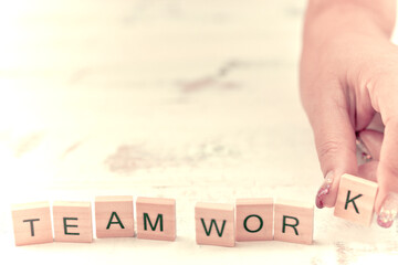 Alphabet Team work on old white vintage wood