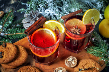 Christmas hot mulled wine in a glass with spices and citrus fruits .