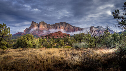 Low Cloud hanging around the Red Rocks of Munds Mountain after a heavy rainfall near the town of Sedona in northern Arizona in Coconino National Forest, USA