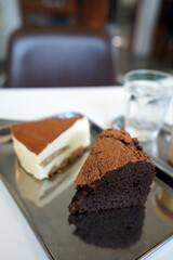 Latte coffee served with Tiramisu cake and chocolate gateau