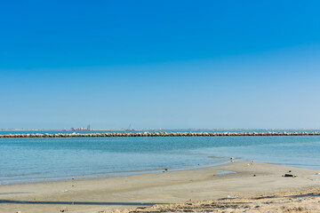 Blue sea and beach with blue sky at the corniche park in Dammam, Kingdom of Saudi Arabia