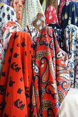 Stack rolls of colorful fabric textile store