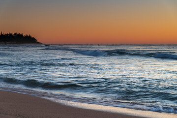 Clear skies and small waves, dawn at the beach