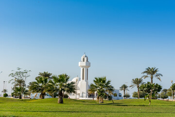 A common small mosque, Al Essa and Al Dowayan Mosque, with palm tree in the corniche coastal park in Dammam, Kingdom of Saudi Arabia