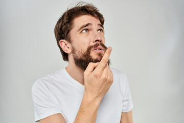 Bearded man gesturing with hand white cropped t-shirt studio lifestyle