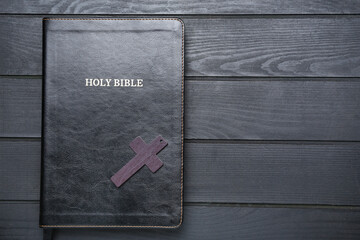 Hole Bible and cross on wooden table
