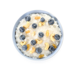 Bowl of tasty rice pudding with blueberry and cashew on white background