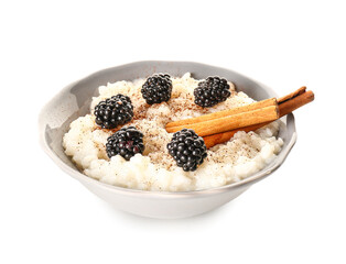 Bowl of tasty rice pudding with blackberry and cinnamon on white background