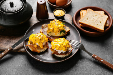 Plate with tasty eggs Benedict on table