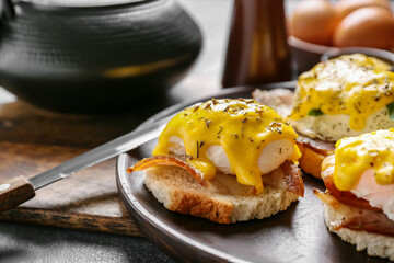 Plate with tasty eggs Benedict on table, closeup
